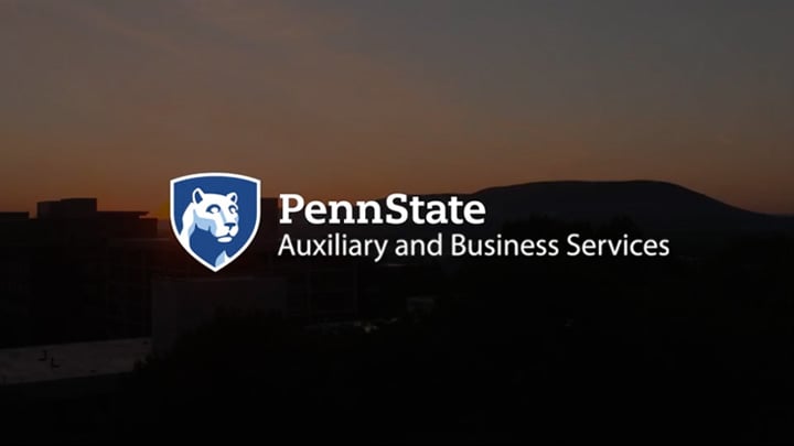 Auxiliary and Business Services logo on a background of the sun rising over Mount Nittany.